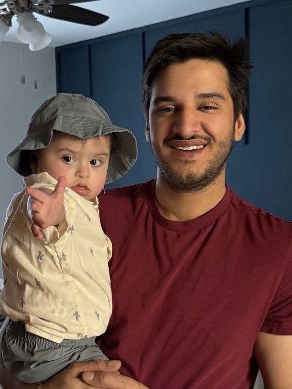 Mikhail, founder of Atticus, with his child